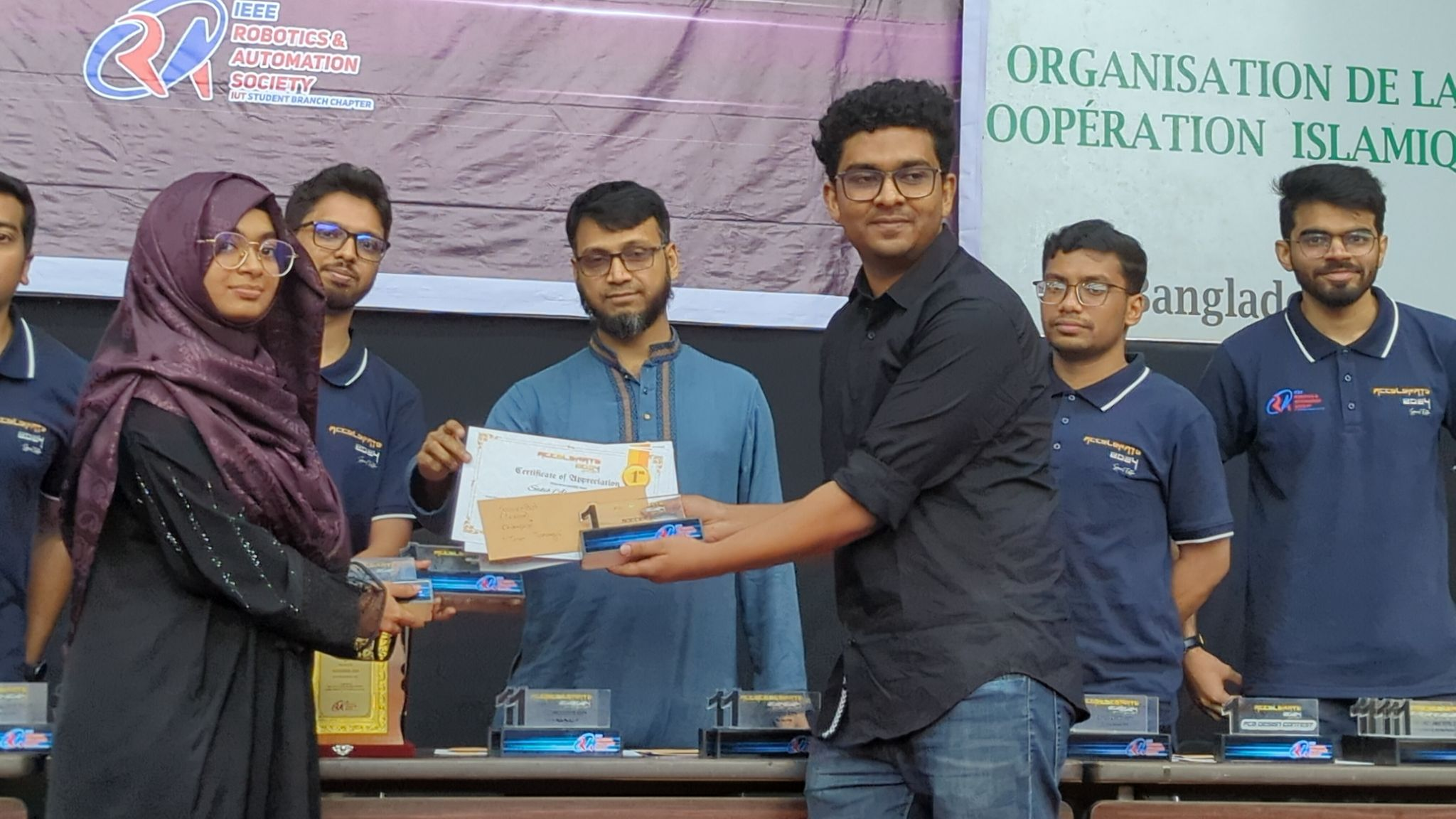 Sakib Ahmed Shanto receiving Soccer Bot Competition first position trophy at IEEERAS IUT